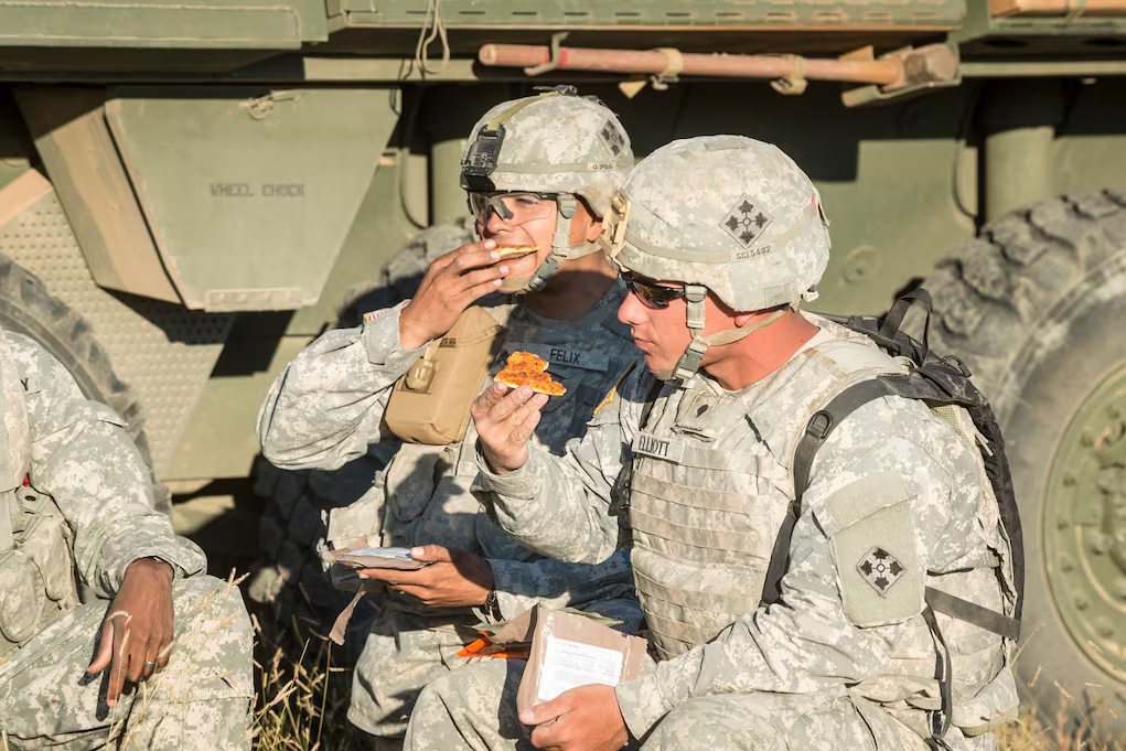 Soldiers with the 4th Infantry Division at Fort Carson, Colorado, try the pizza MRE in 2014. After more recent modifications, now it's ready to be packaged into MREs. (David Kamm/U.S. Army Natick Soldier Research, Development and Engineering Center)